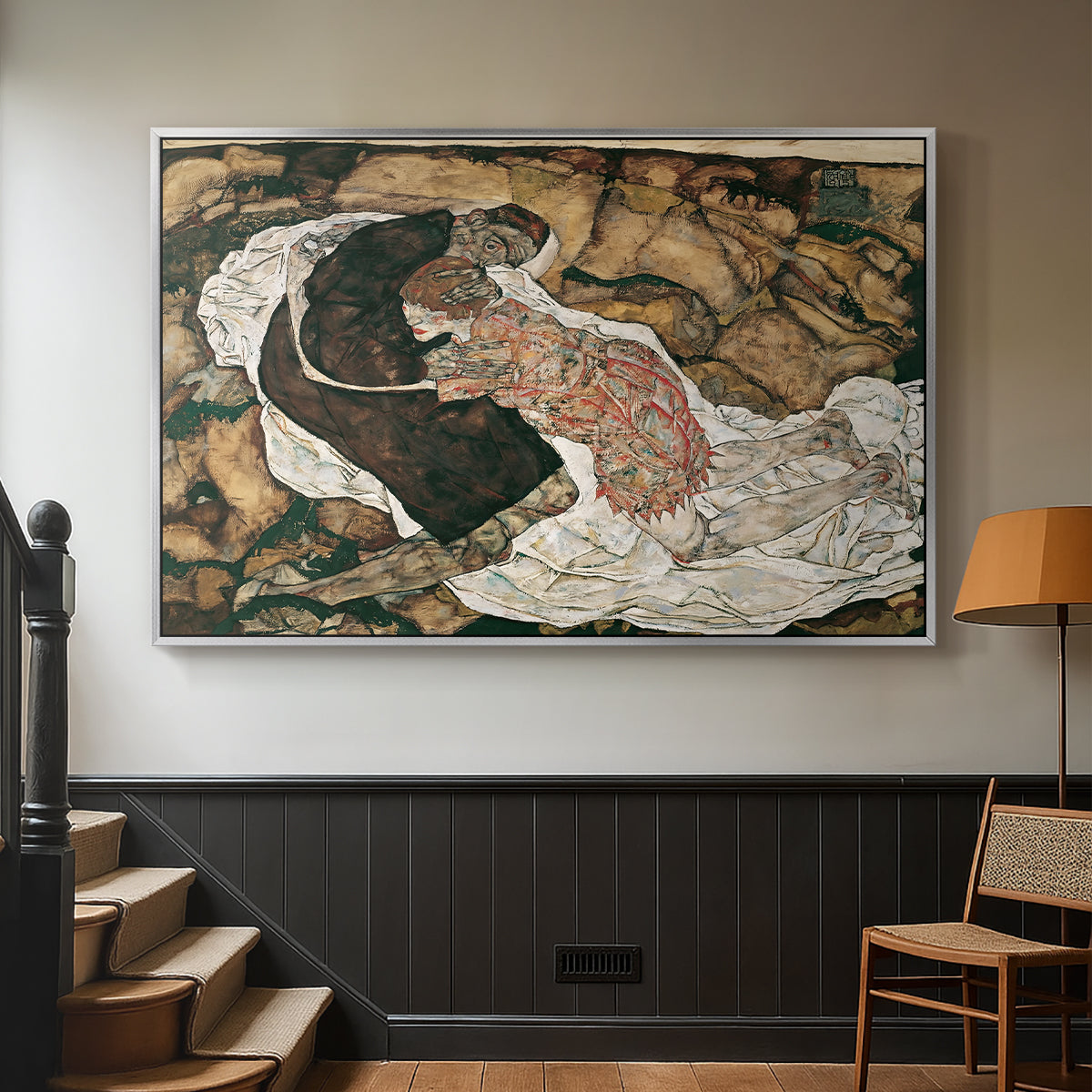 Silver floater framed canvas featuring an intense composition exploring life and death through figures, displayed in a hallway near a staircase.
