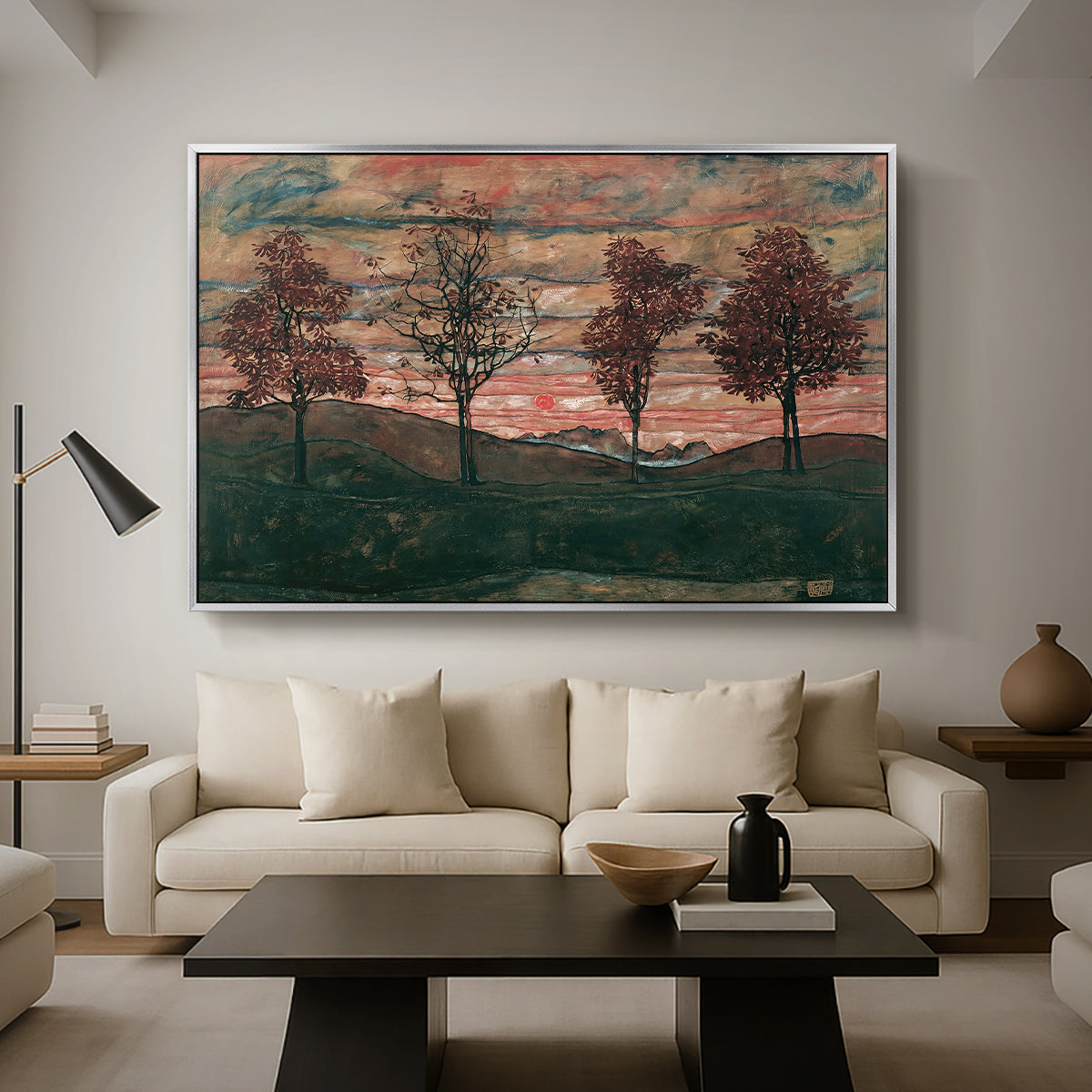 Four Trees, 1917 by Egon Schiele as a silver floater framed canvas featuring four trees standing in open landscape against colorful sky, displayed above a sofa in a modern living room.