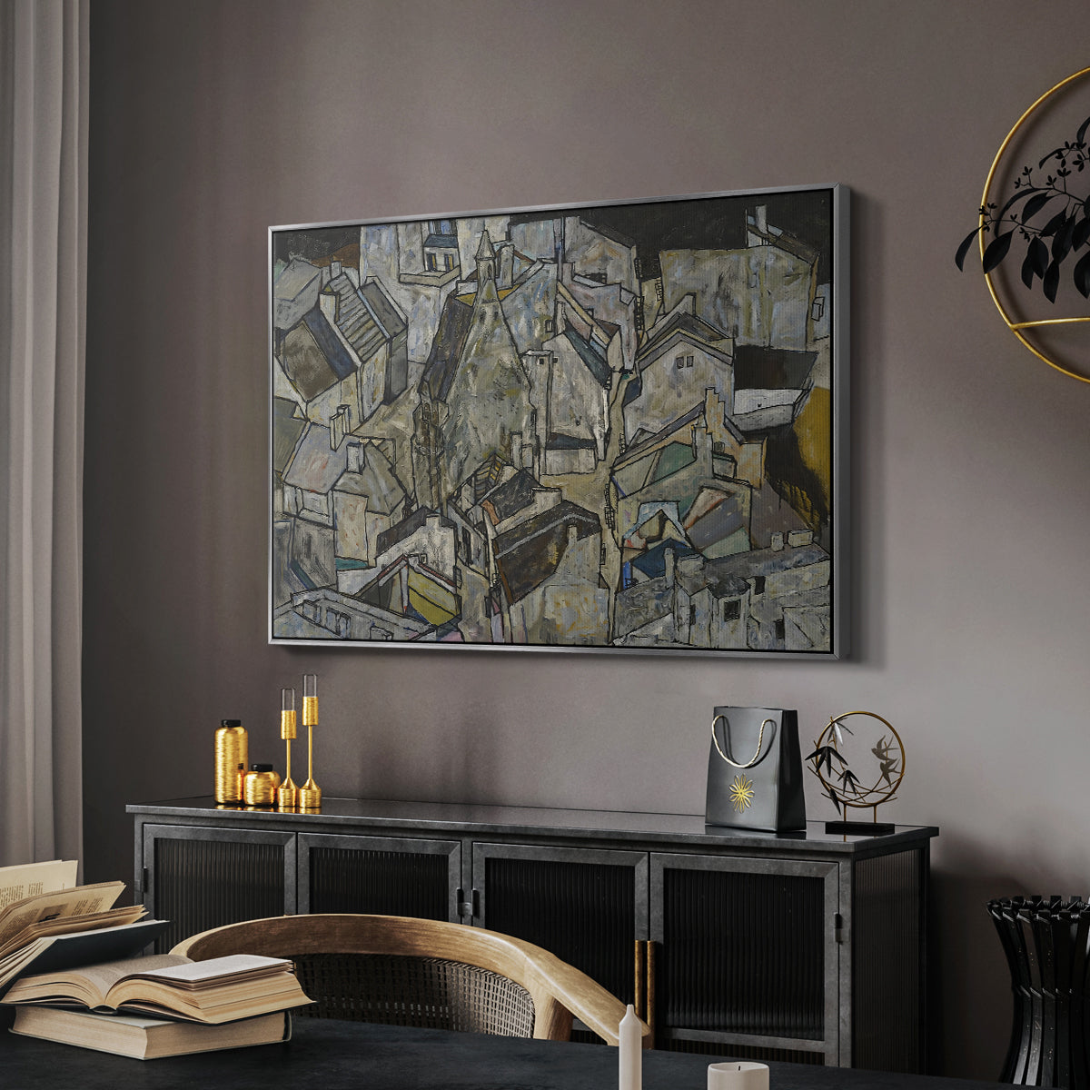Mödling II, 1918 by Egon Schiele in a silver floater framed canvas featuring an abstracted town view with angular rooftops and fragmented forms, displayed above a desk in a dark home office interior.