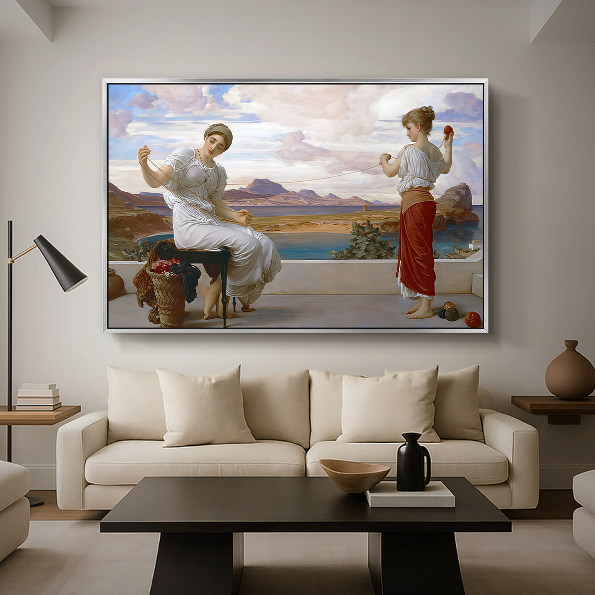 Winding the Skein, c. 1878 by Frederic Leighton as a silver floater framed canvas featuring a woman holding thread while another figure helps wind yarn in classical setting, displayed above a sofa in a modern living room.