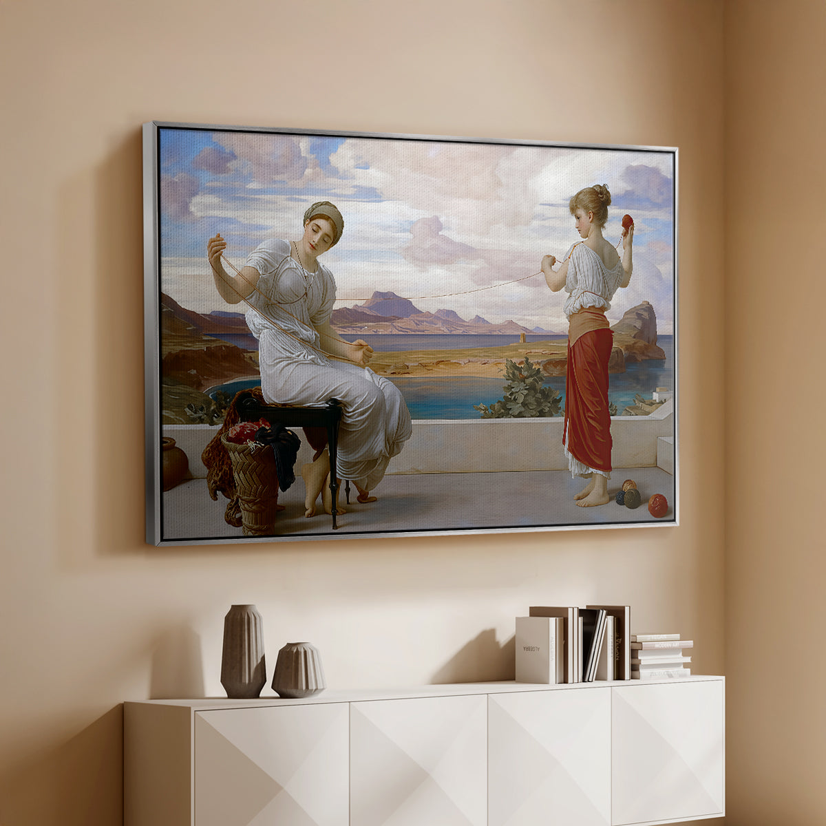Silver floater framed canvas of Winding the Skein, c. 1878 by Frederic Leighton, featuring two women engaged in textile work with draped garments above a console cabinet in a minimalist entryway.