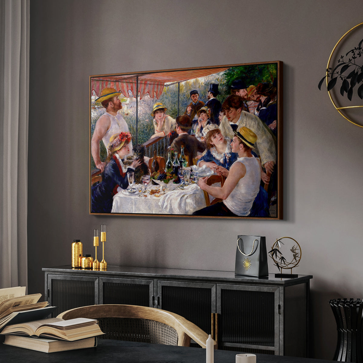 Luncheon of the Boating Party (Le Déjeuner des canotiers), 1880-1881 by Pierre-Auguste Renoir in a walnut floater framed canvas featuring an impressionist scene of friends enjoying lunch with wine and conversation, displayed above a desk in a dark home office interior.