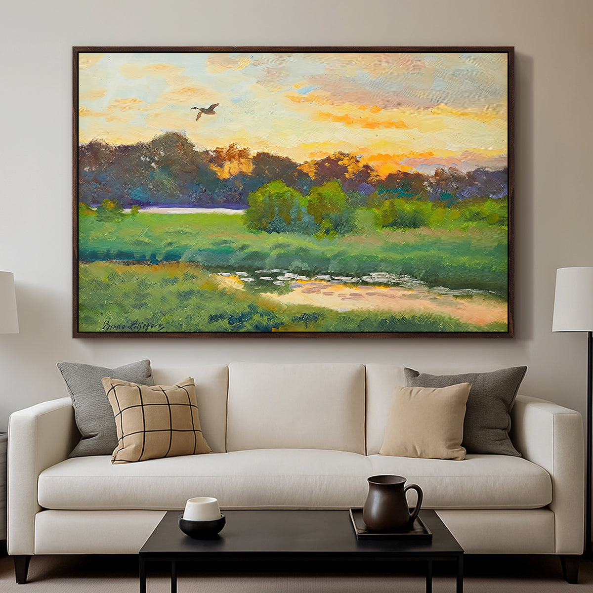 Flying Duck at Sunset, 1924 by Bruno Liljefors displayed in a walnut floater framed canvas above a sofa in a clean living room.