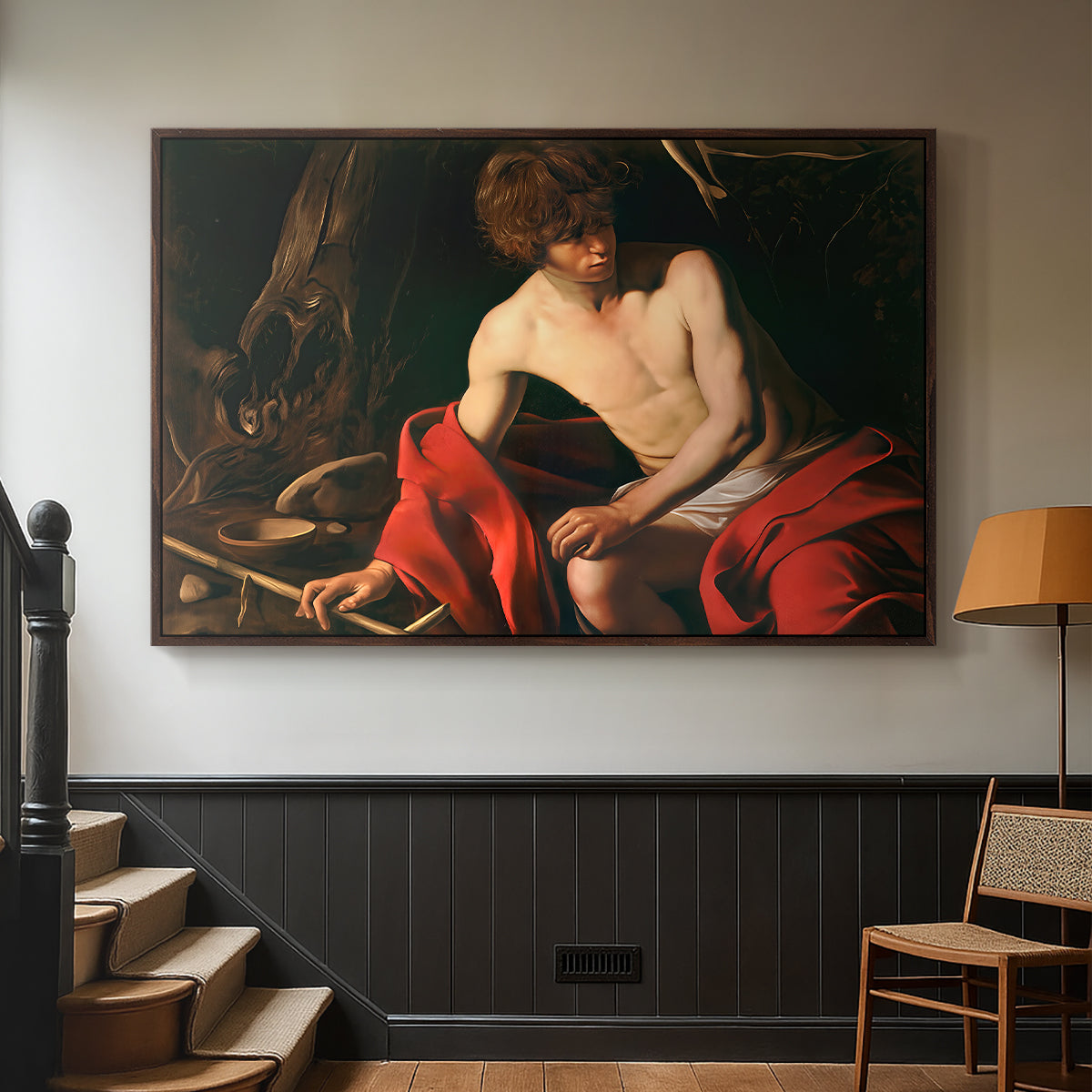 Walnut floater framed canvas featuring a contemplative religious figure in rustic wilderness environment, displayed in a hallway near a staircase.