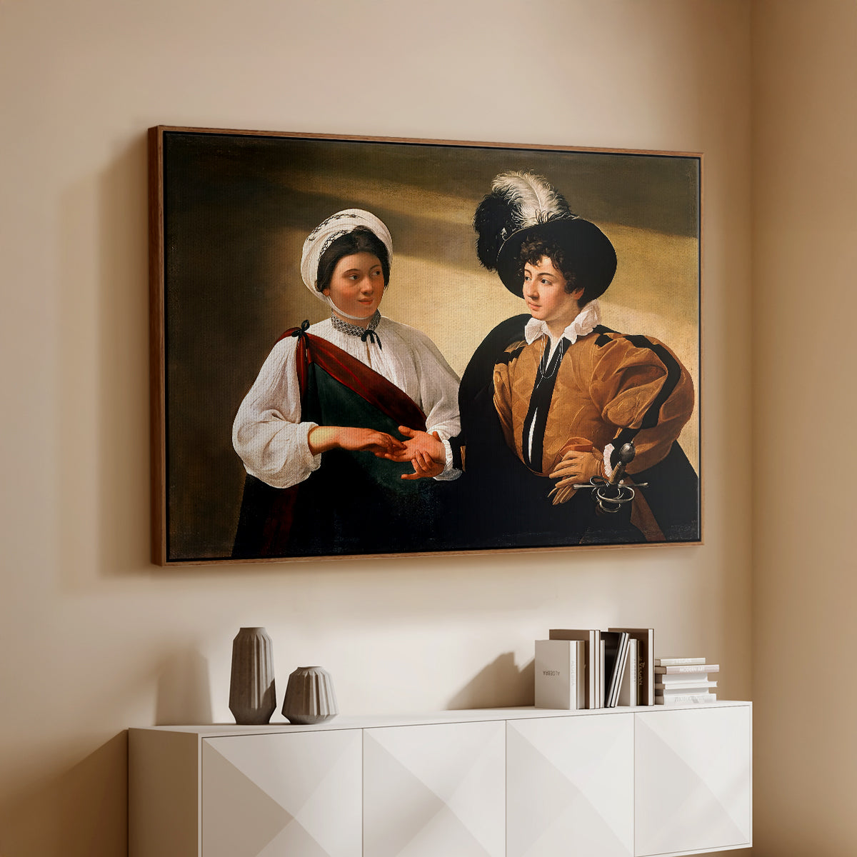 Walnut floater framed canvas of The Fortune Teller (Louvre Version), c. 1595 by Caravaggio, featuring a fortune teller examining hand of man as she slyly removes his ring above a console cabinet in a minimalist entryway.