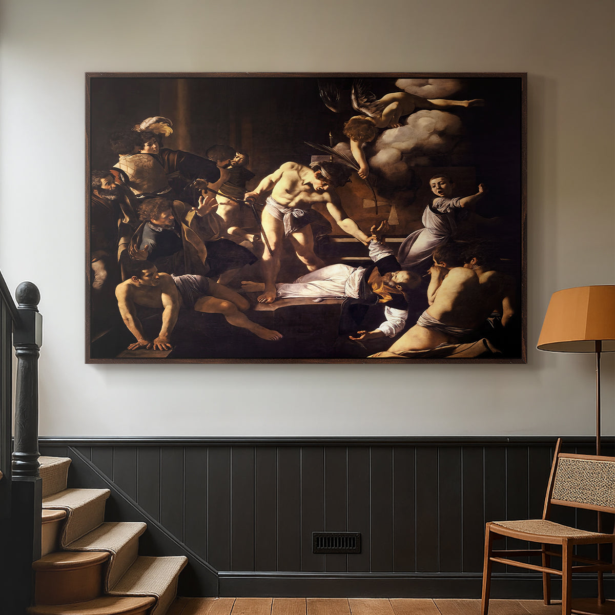 Walnut floater framed canvas featuring a Baroque composition of movement and emotion during martyrdom, displayed in a hallway near a staircase.
