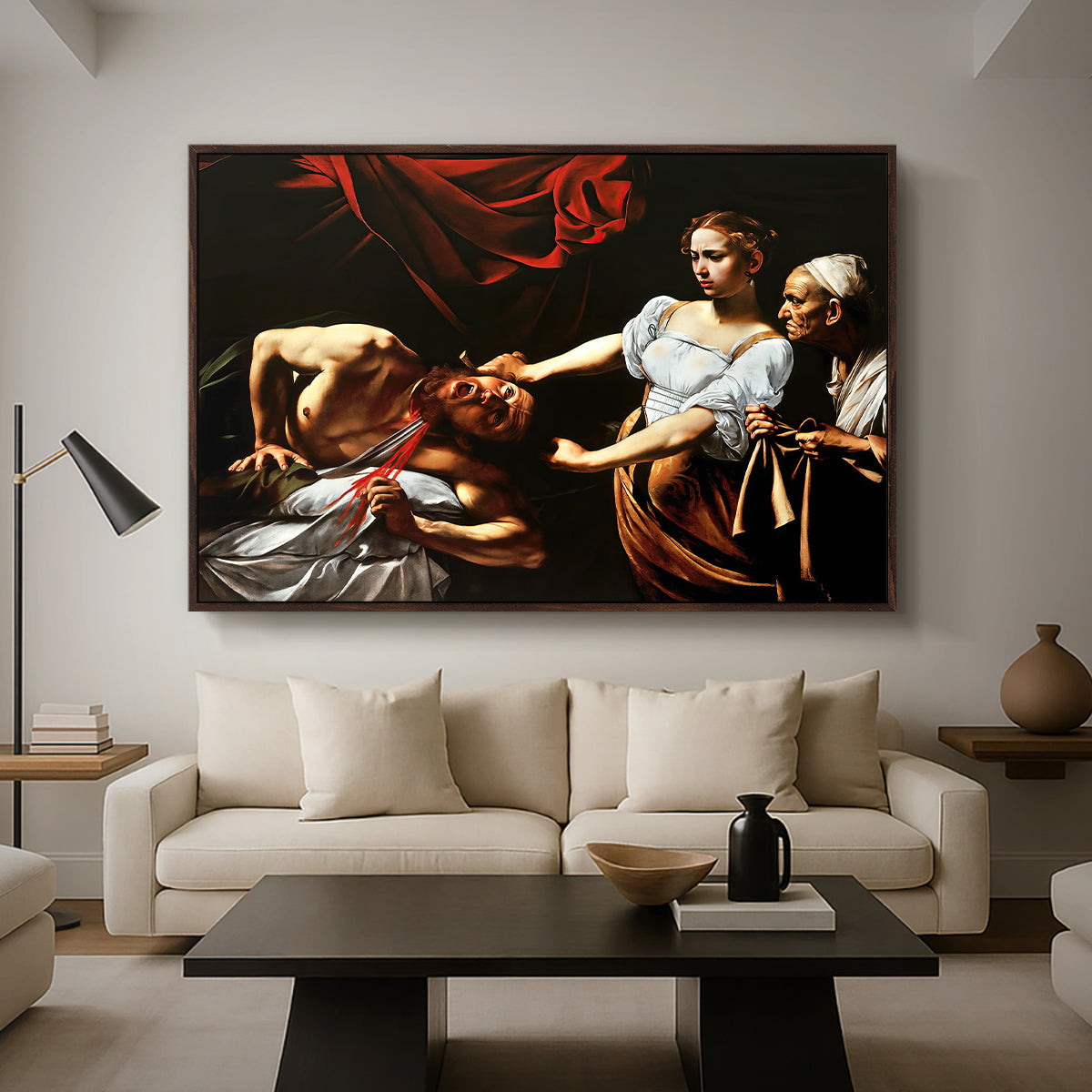 Judith Beheading Holofernes, c. 1599 by Caravaggio as a walnut floater framed canvas featuring Judith cutting off Holofernes' head as maidservant assists beside her, displayed above a sofa in a modern living room.