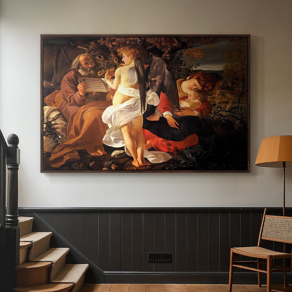 Walnut floater framed canvas featuring a Baroque landscape with angel playing music for resting travelers, displayed in a hallway near a staircase.