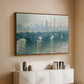 Walnut floater framed canvas of Waterloo Bridge, Gray Weather, 1900 by Claude Monet, featuring an impressionist cityscape with bridge fading into fog over water above a console cabinet in a minimalist entryway.