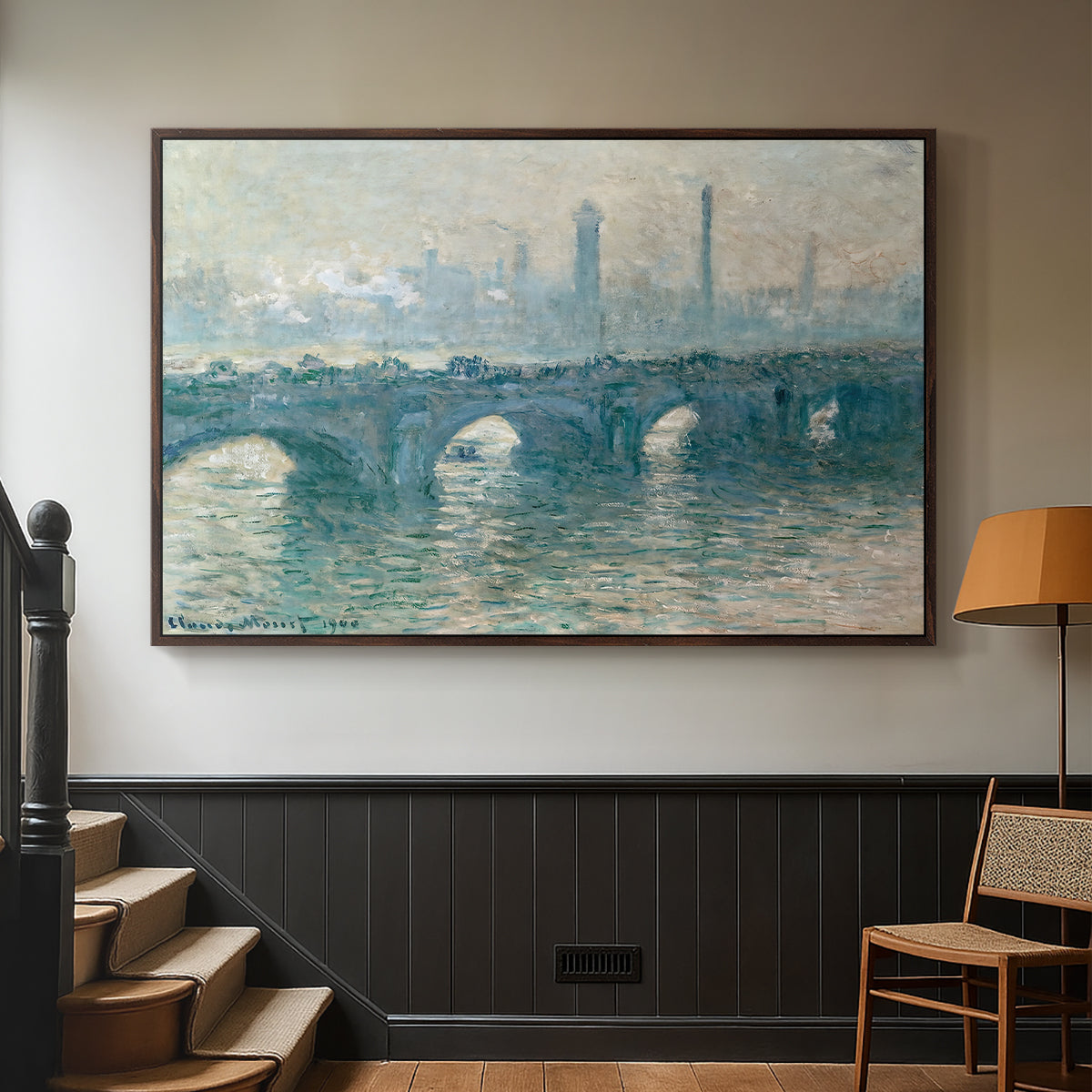 Walnut floater framed canvas featuring an atmospheric urban landscape with misty light and reflections, displayed in a hallway near a staircase.