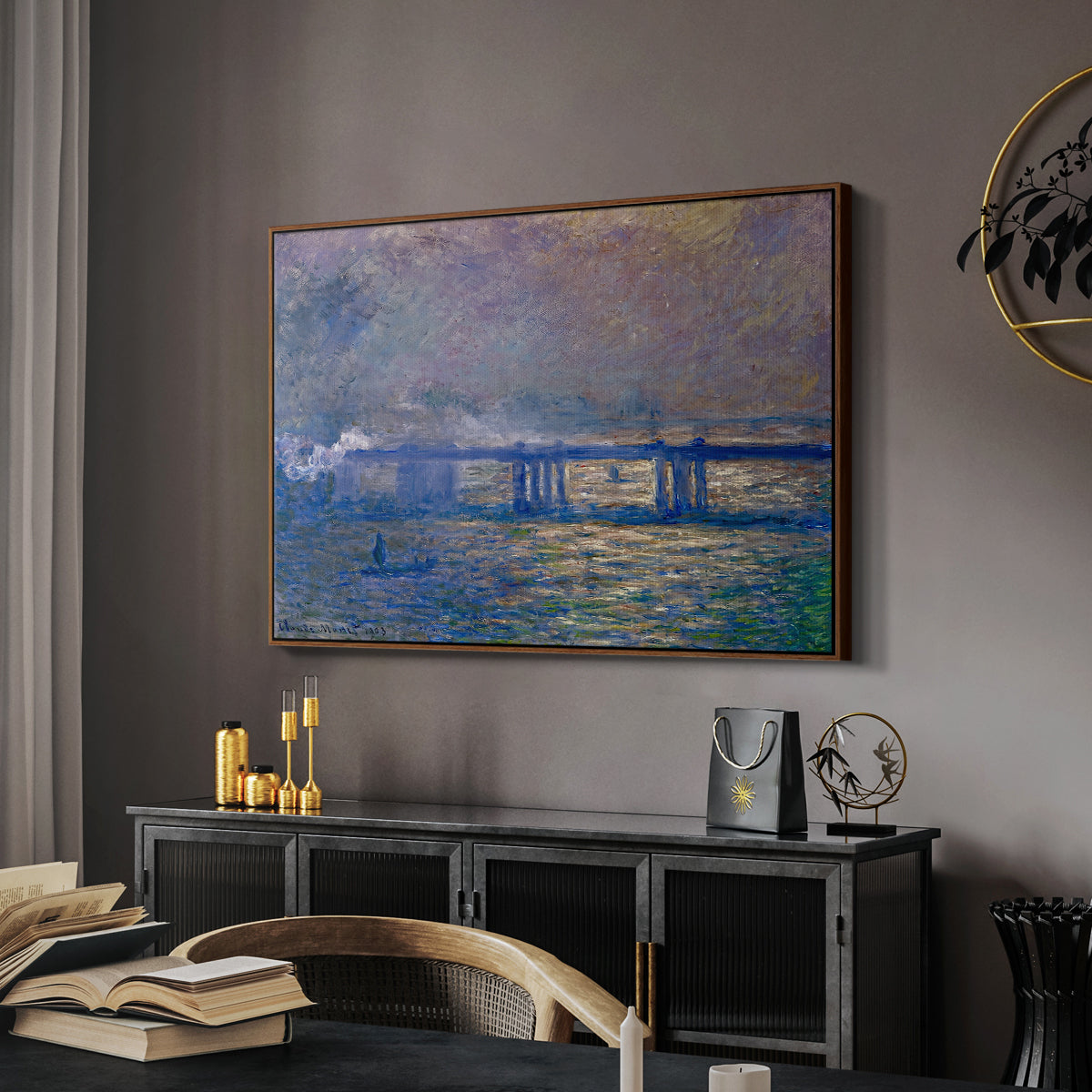 Charing Cross Bridge, 1903 by Claude Monet in a walnut floater framed canvas featuring an atmospheric depiction of London bridge with reflections in water, displayed above a desk in a dark home office interior.