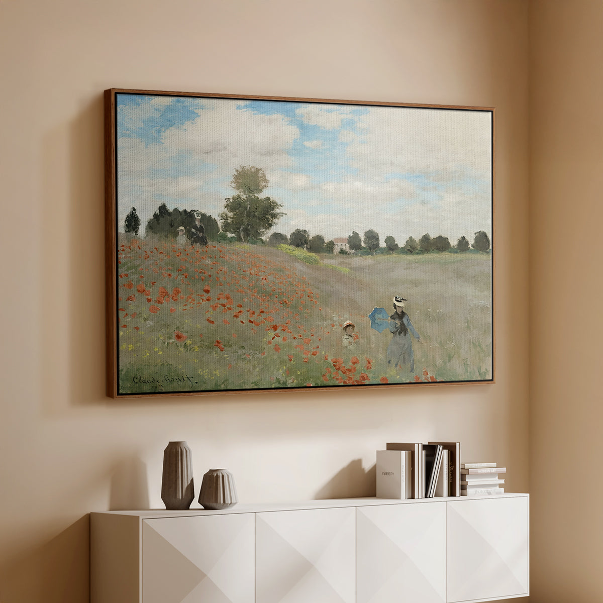 Walnut floater framed canvas of The Poppy Field near Argenteuil, 1873 by Claude Monet, featuring an impressionist countryside scene with flowers and strolling figures above a console cabinet in a minimalist entryway.
