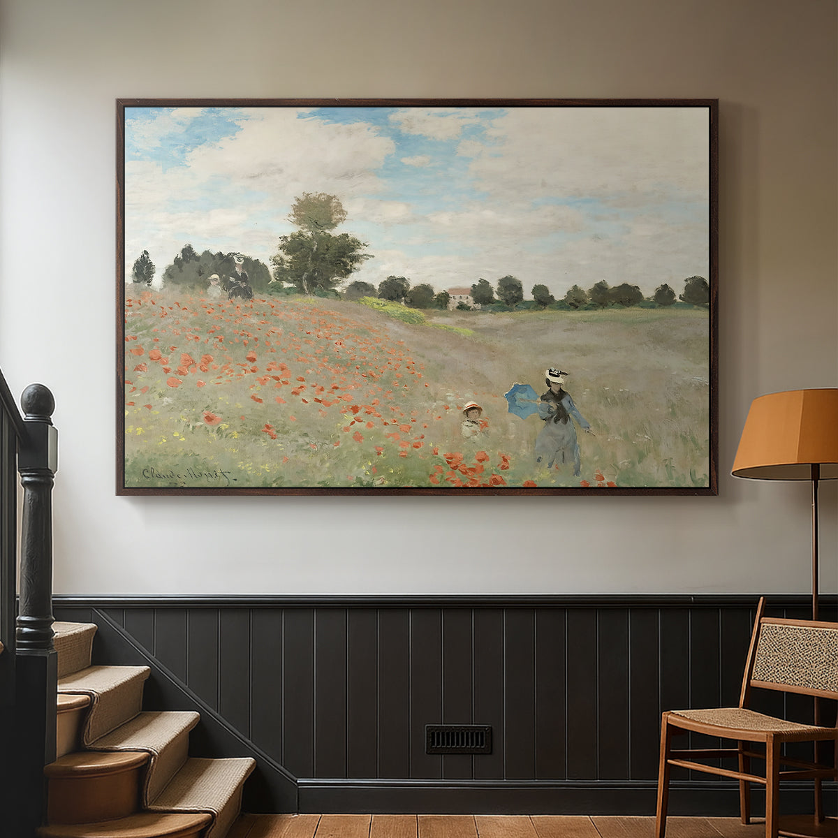Walnut floater framed canvas featuring a rural landscape with scattered figures among blooming flowers, displayed in a hallway near a staircase.