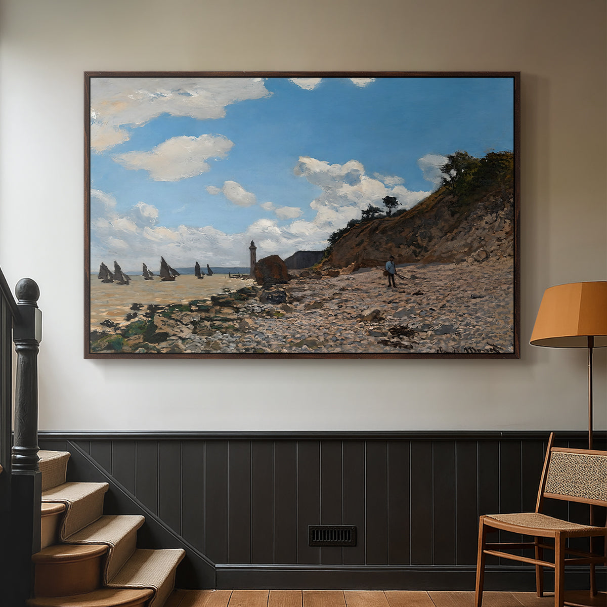 Walnut floater framed canvas featuring a coastal landscape with boats and people along shore, displayed in a hallway near a staircase.