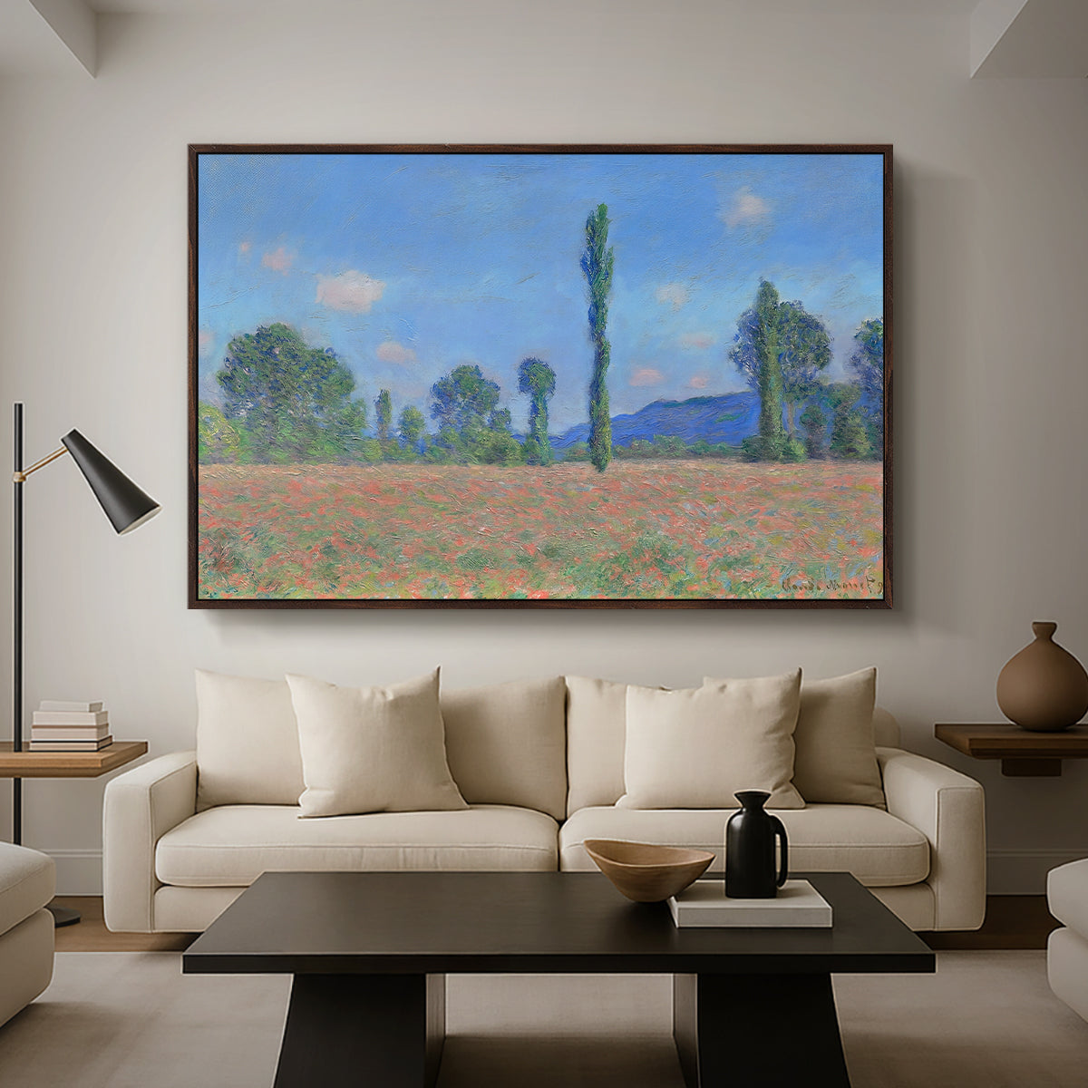 Poppy Field (Giverny), 1890-1891 by Claude Monet as a walnut floater framed canvas featuring an expansive field of red poppies with tall trees under blue sky, displayed above a sofa in a modern living room.