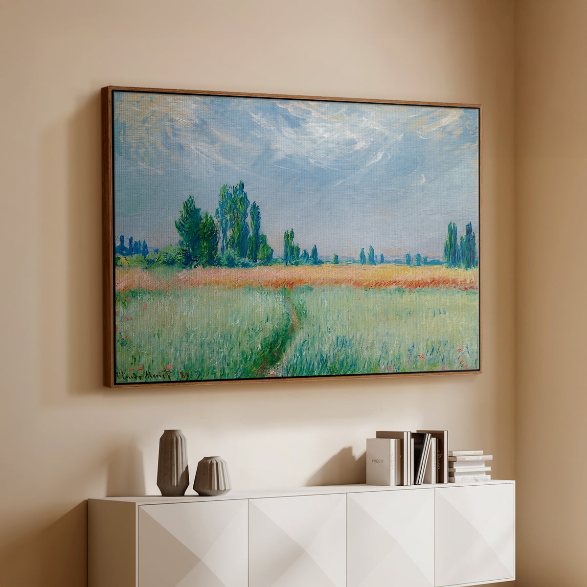 Walnut floater framed canvas of The Wheat Field (Champ de Blé), 1881 by Claude Monet, featuring an impressionist depiction of ripened grain field in countryside above a console cabinet in a minimalist entryway.