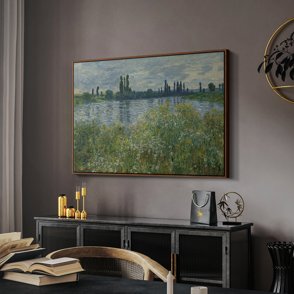 Banks of the Seine, Vétheuil, 1880 by Claude Monet in a walnut floater framed canvas featuring a tranquil riverside scene with houses and vegetation, displayed above a desk in a dark home office interior.