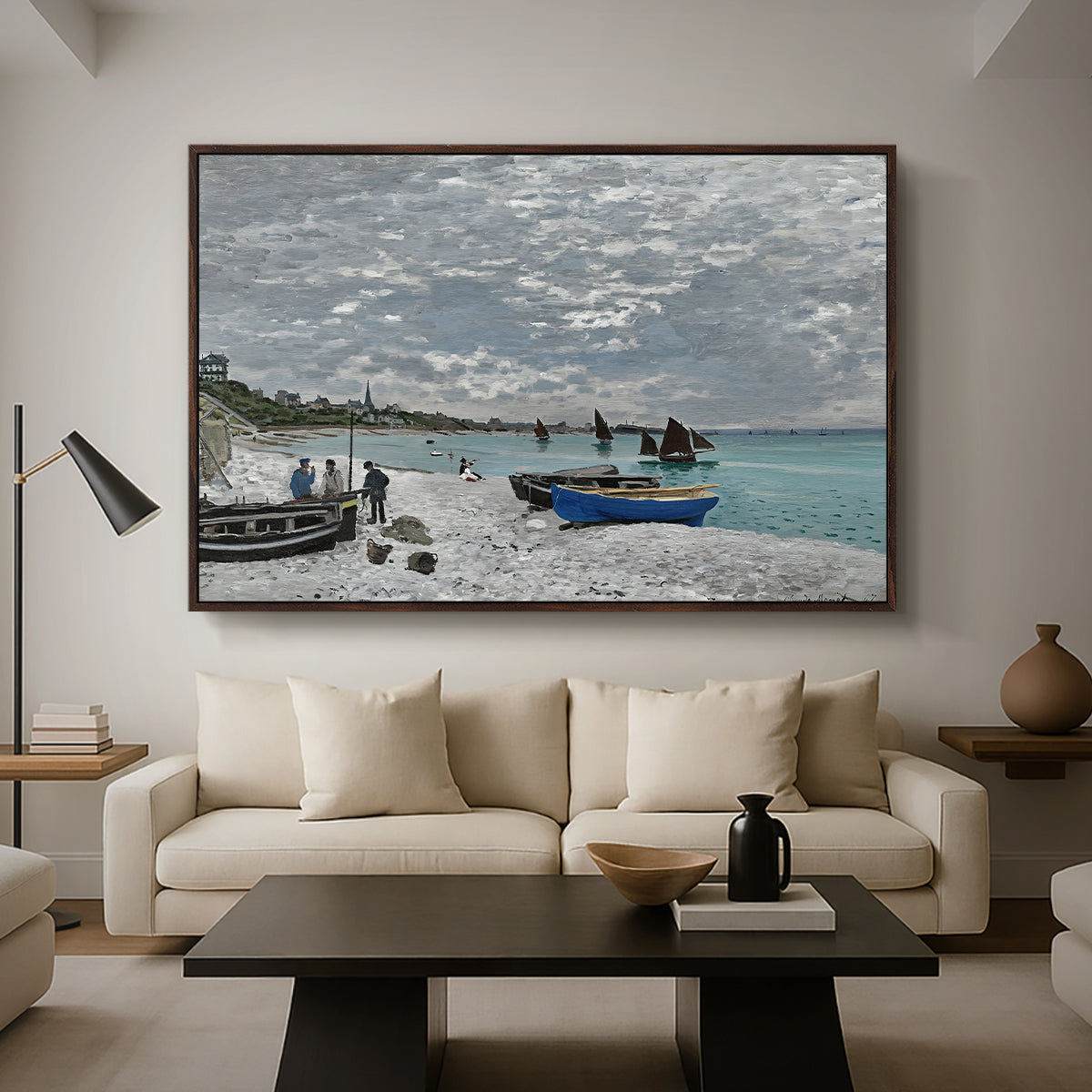 The Beach at Sainte-Adresse, 1867 by Claude Monet as a walnut floater framed canvas featuring a seaside promenade with figures, flags, and boats along the coast, displayed above a sofa in a modern living room.