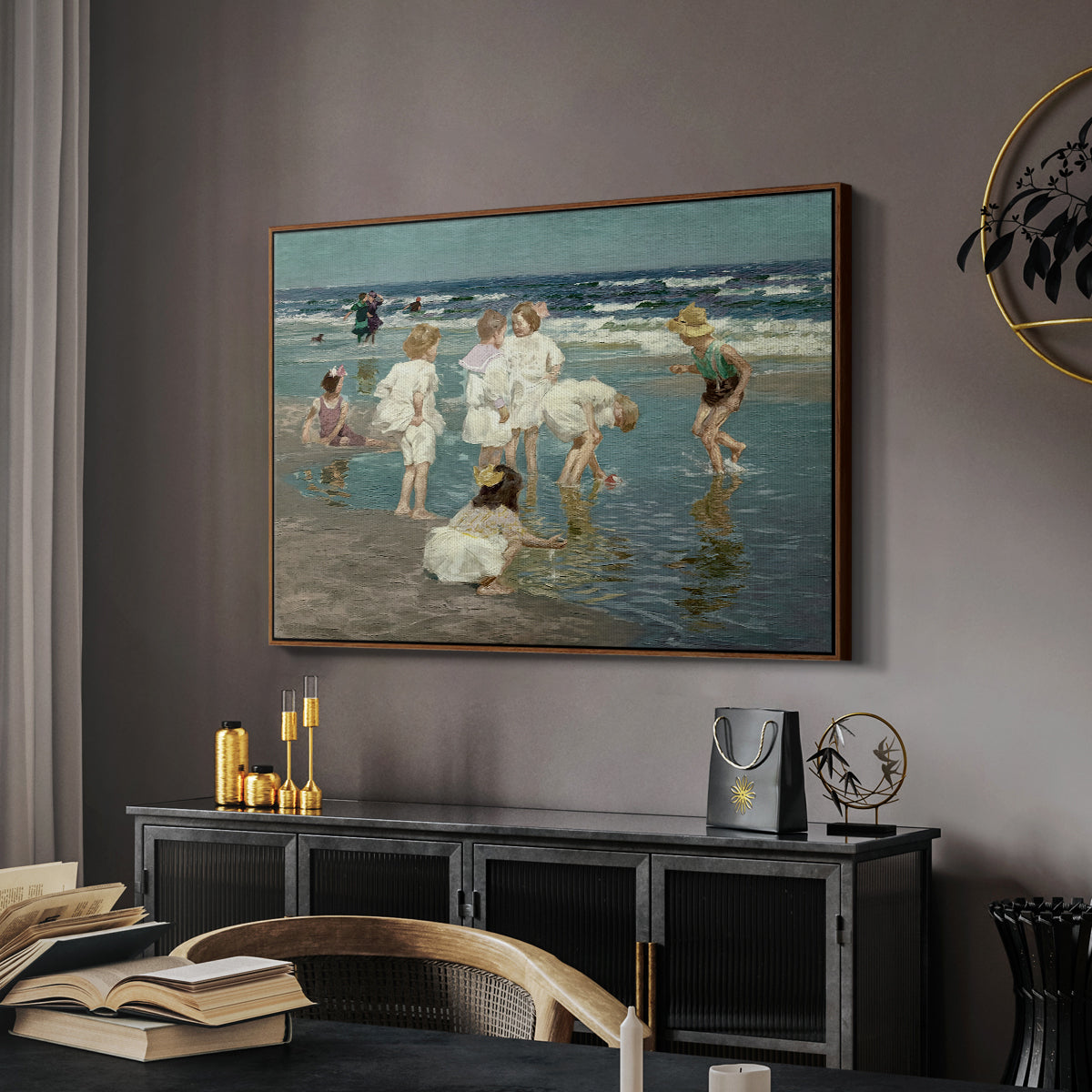 A Holiday, c. 1915 by Edward Henry Potthast in a walnut floater framed canvas featuring an impressionist coastal view of families enjoying seaside water, displayed above a desk in a dark home office interior.