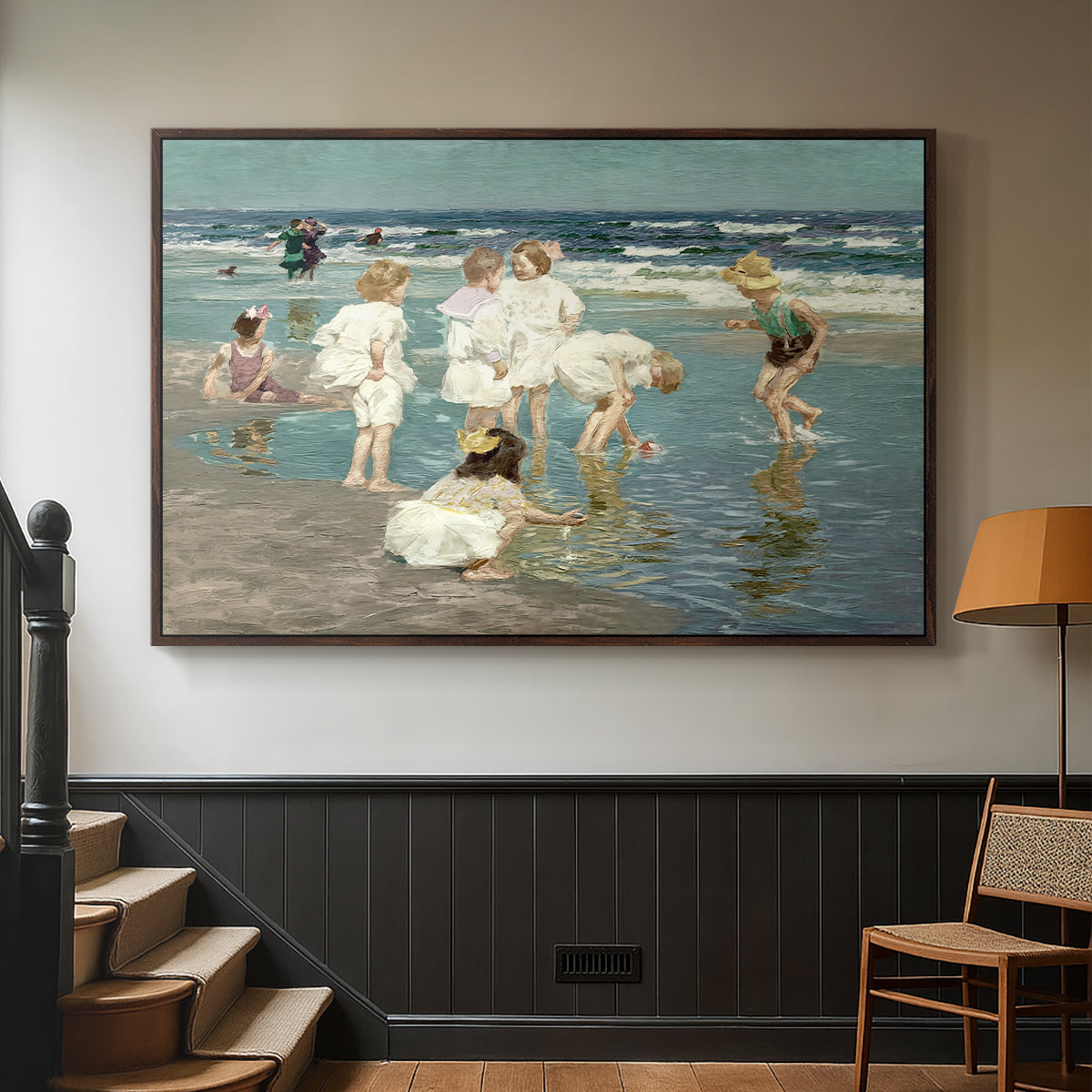 Walnut floater framed canvas featuring a lively shoreline scene with people gathered in surf, displayed in a hallway near a staircase.