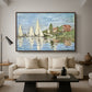 Regatta at Argenteuil, 1872 by Claude Monet as a walnut floater framed canvas featuring colorful sailboats racing across river under bright sky, displayed above a sofa in a modern living room.