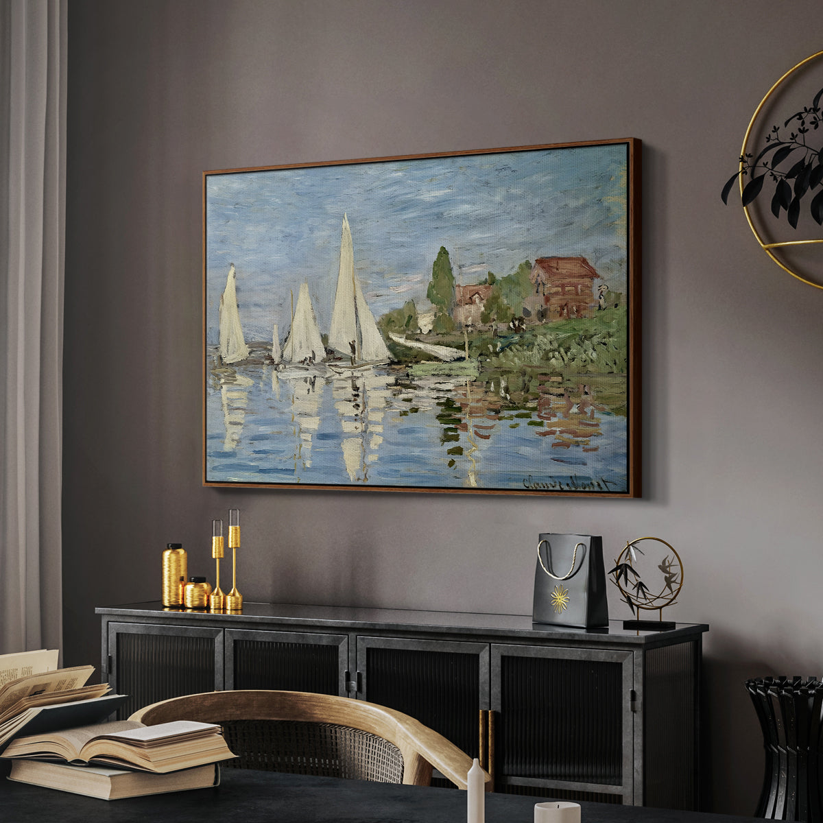 Regatta at Argenteuil, 1872 by Claude Monet in a walnut floater framed canvas featuring an impressionist depiction of sailing competition on water, displayed above a desk in a dark home office interior.