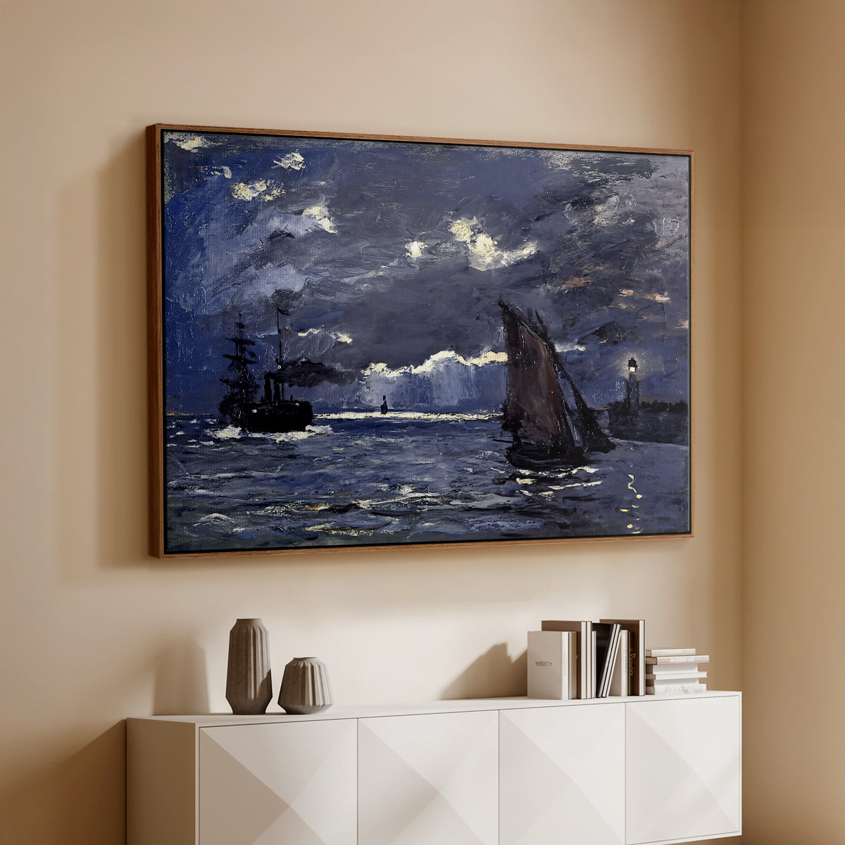 Walnut floater framed canvas of A Seascape, Shipping by Moonlight, 1864 by Claude Monet, featuring a nocturnal seascape with boats silhouetted against glowing moon above a console cabinet in a minimalist entryway.