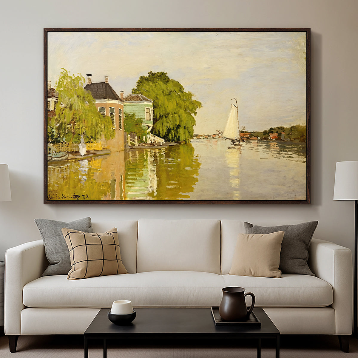 Houses on the Achterzaan, 1871 by Claude Monet displayed in a walnut floater framed canvas above a sofa in a clean living room.