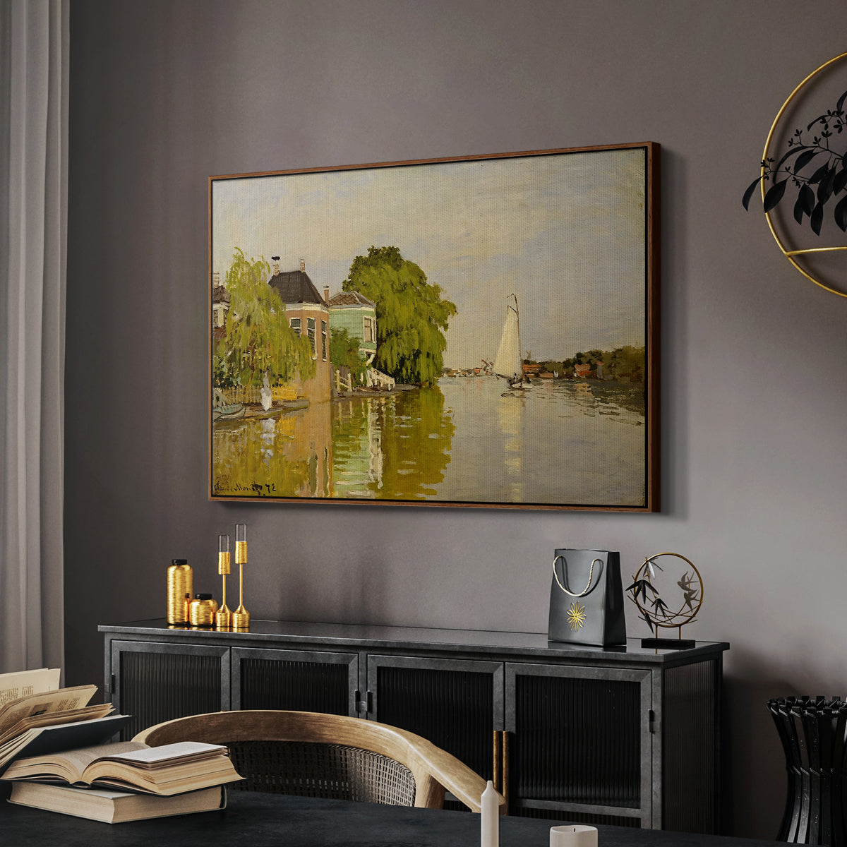 Houses on the Achterzaan, 1871 by Claude Monet in a walnut floater framed canvas featuring an impressionist landscape with buildings along quiet canal, displayed above a desk in a dark home office interior.