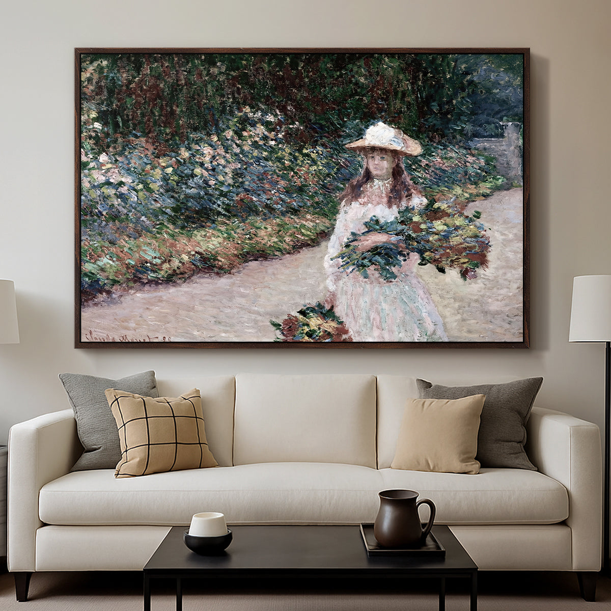 Young Girl in the Garden at Giverny, 1888 by Claude Monet displayed in a walnut floater framed canvas above a sofa in a clean living room.