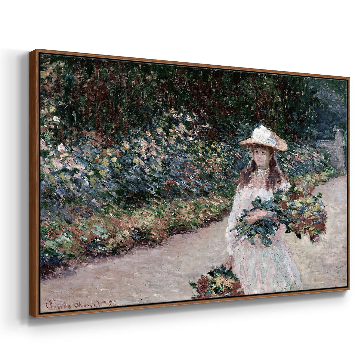 Angled view of Young Girl in the Garden at Giverny, 1888 by Claude Monet in a walnut floater framed canvas.