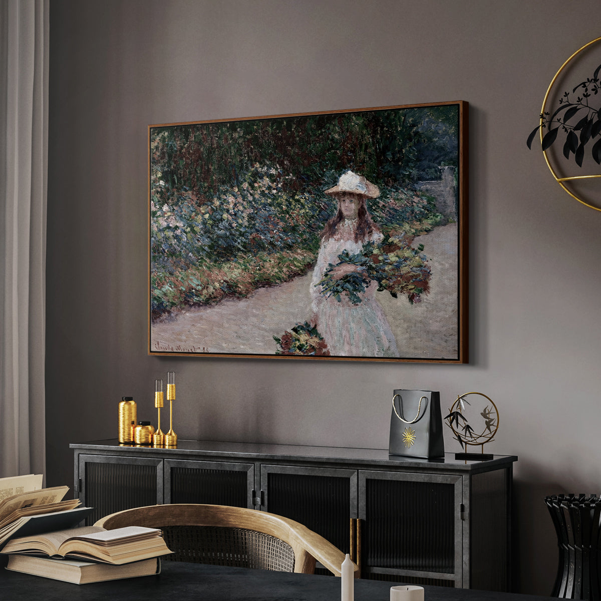 Young Girl in the Garden at Giverny, 1888 by Claude Monet in a walnut floater framed canvas featuring a figure resting in colorful garden under soft light, displayed above a desk in a dark home office interior.