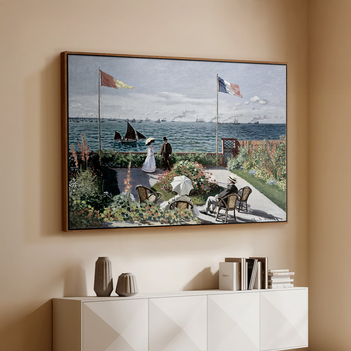 Walnut floater framed canvas of Garden at Sainte-Adresse, 1867 by Claude Monet, featuring an impressionist coastal garden with people and ocean view above a console cabinet in a minimalist entryway.