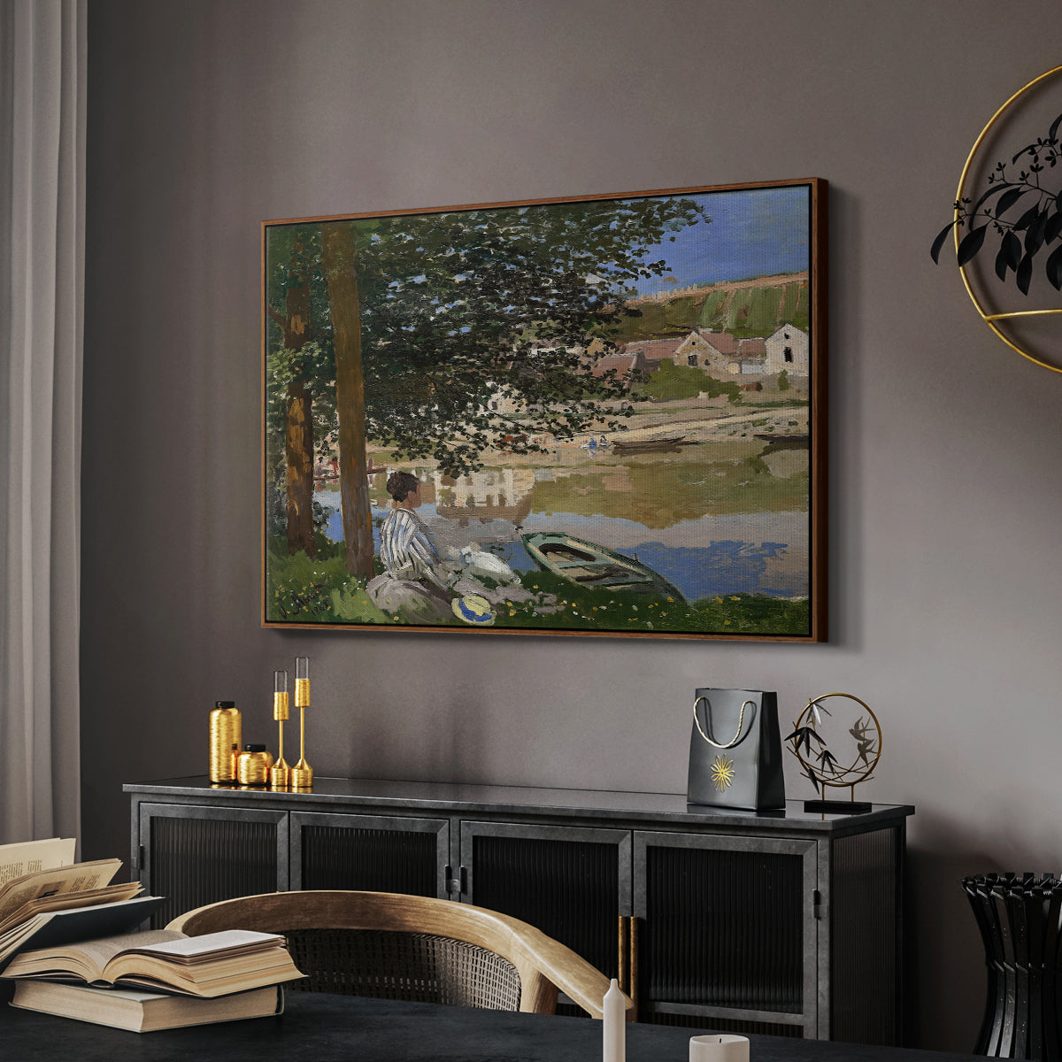 On the Bank of the Seine, Bennecourt, 1868 by Claude Monet in a walnut floater framed canvas featuring an impressionist landscape with people relaxing along the Seine, displayed above a desk in a dark home office interior.