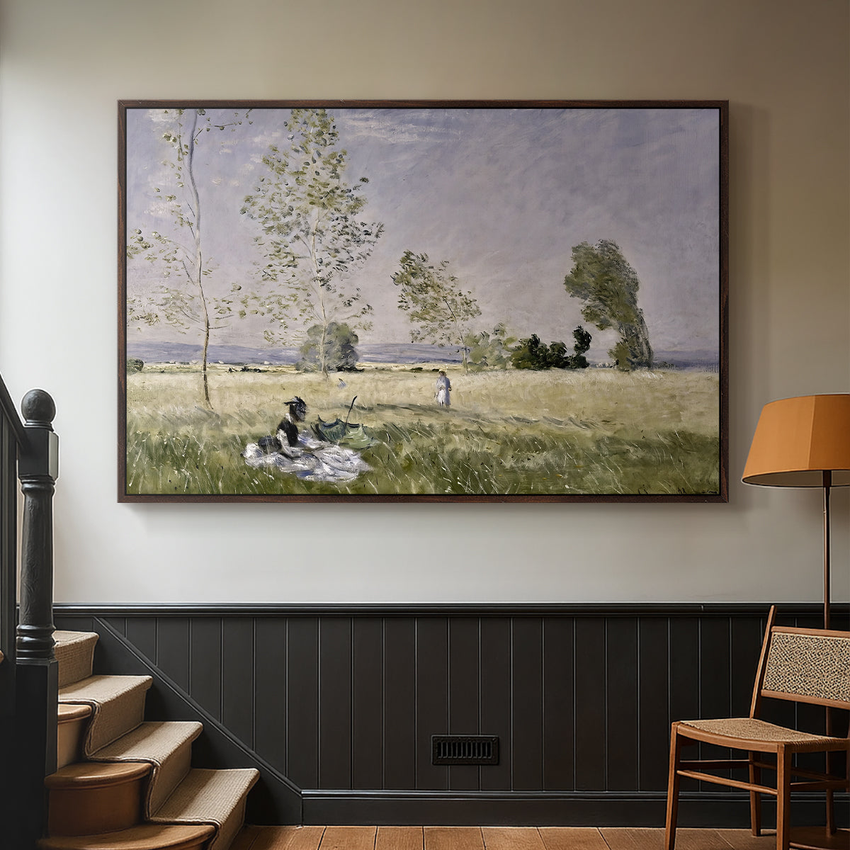 Walnut floater framed canvas featuring a tranquil summer landscape with lone figure in nature, displayed in a hallway near a staircase.