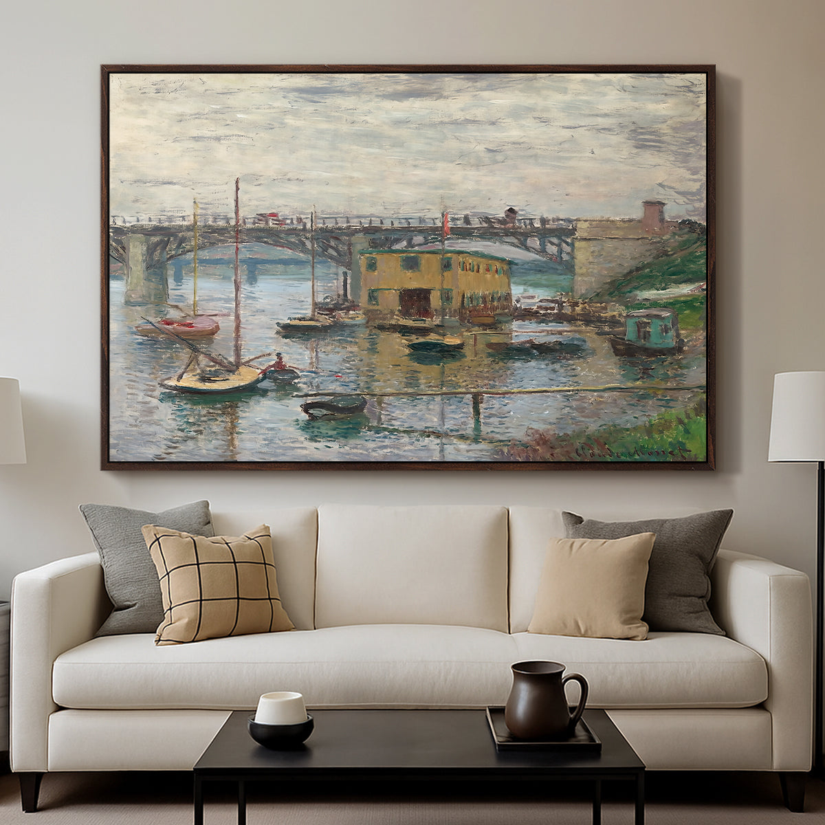 Bridge at Argenteuil on a Gray Day, c. 1876 by Claude Monet displayed in a walnut floater framed canvas above a sofa in a clean living room.