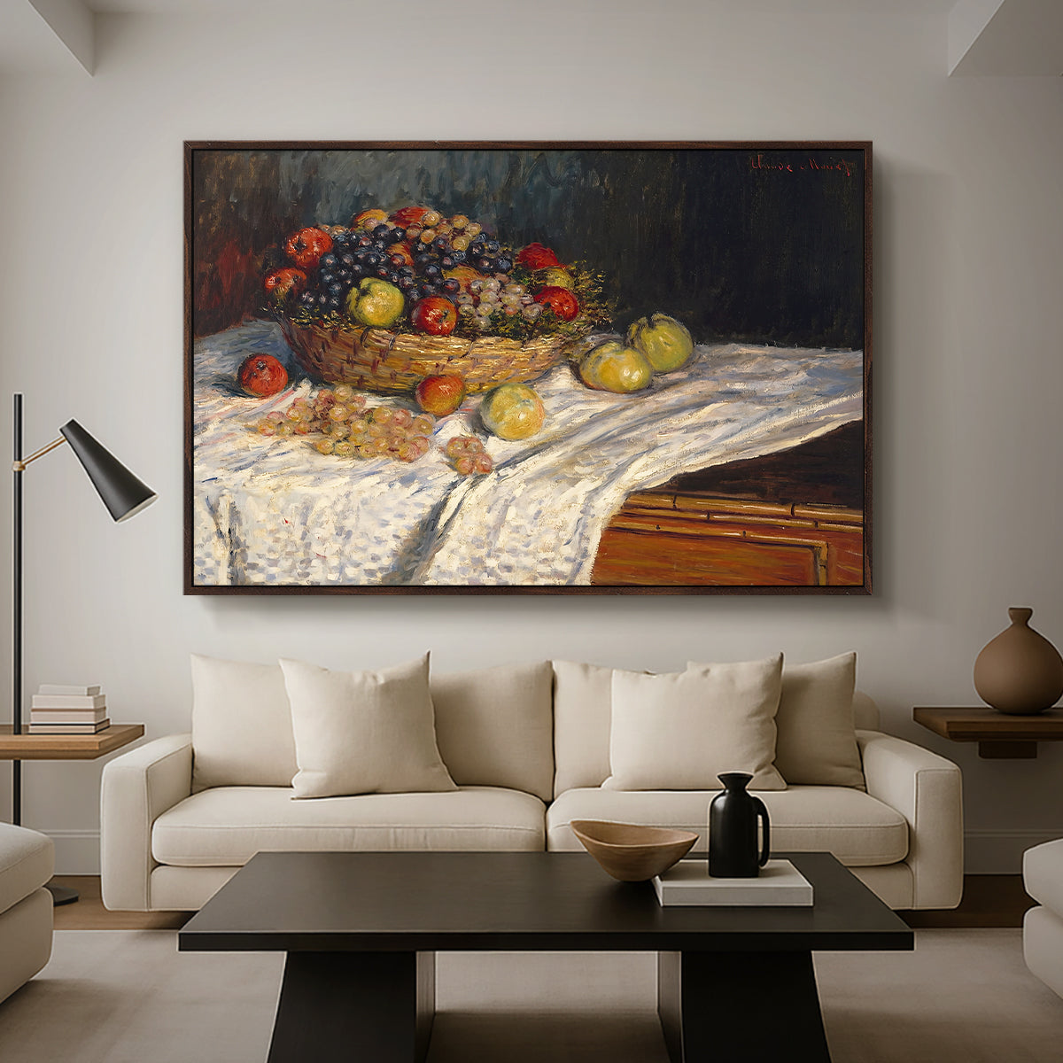 Still Life with Apples and Grapes, 1880 by Claude Monet as a walnut floater framed canvas featuring an arrangement of apples and grapes on table with soft natural light, displayed above a sofa in a modern living room.