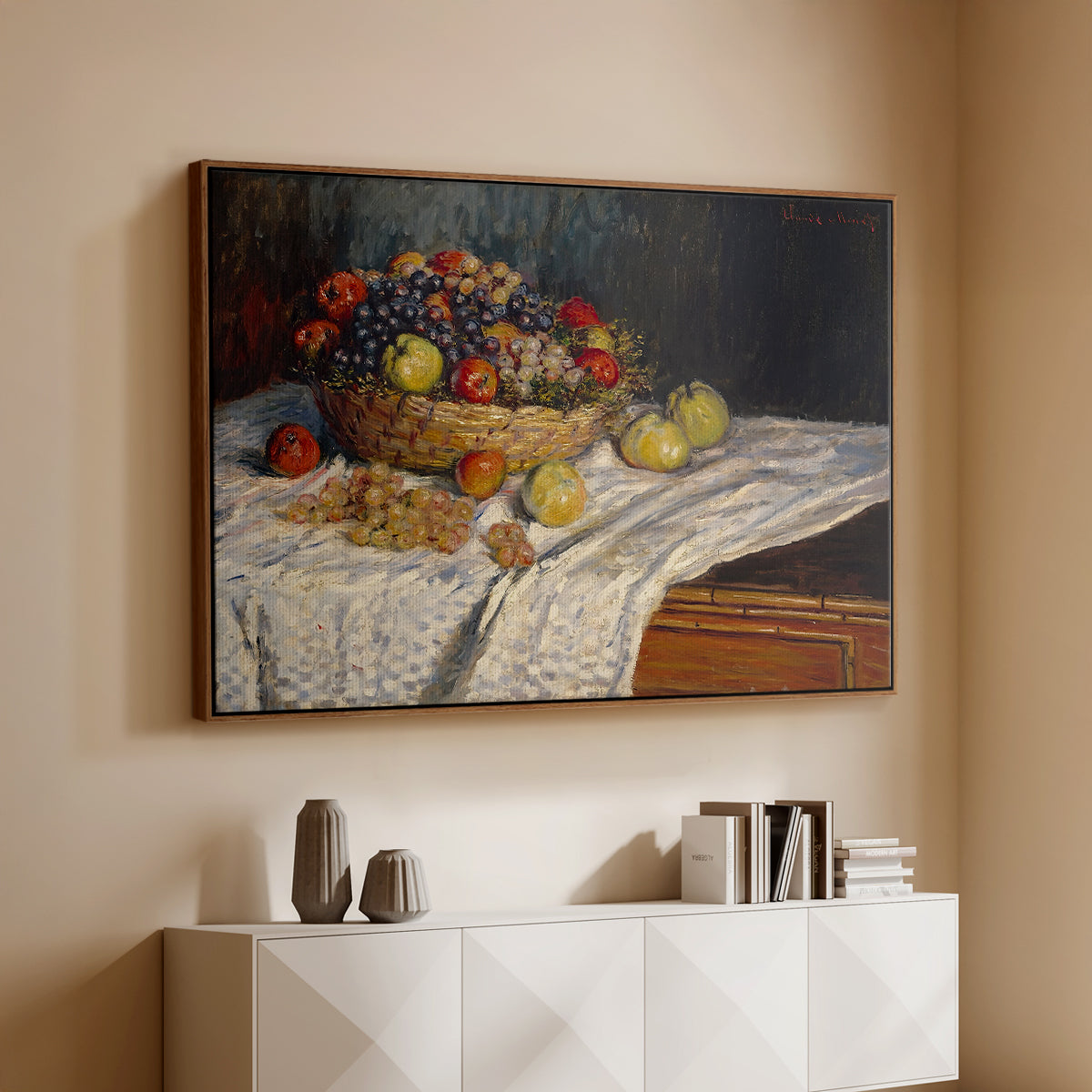 Walnut floater framed canvas of Still Life with Apples and Grapes, 1880 by Claude Monet, featuring an impressionist still life of fruit placed on cloth-covered surface above a console cabinet in a minimalist entryway.