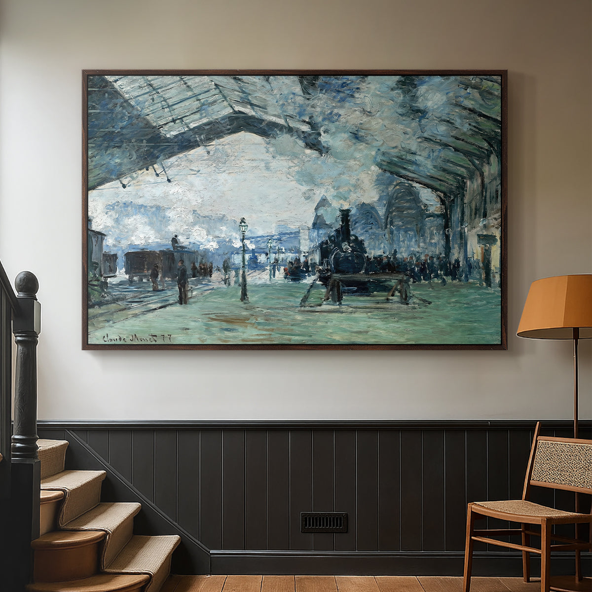 Walnut floater framed canvas featuring a dramatic depiction of industrial space with trains and light, displayed in a hallway near a staircase.