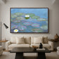 Water Lilies (Nymphéas), 1897-1899 by Claude Monet as a walnut floater framed canvas featuring floating water lilies on pond with reflections of sky and foliage, displayed above a sofa in a modern living room.