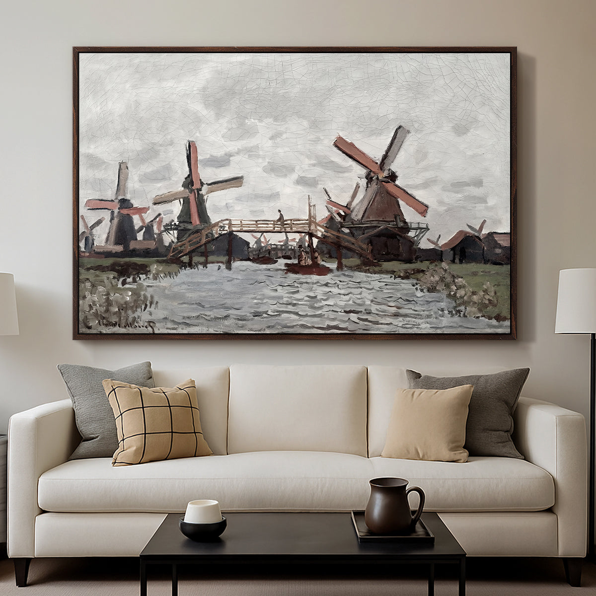 Windmills near Zaandam, 1871 by Claude Monet displayed in a walnut floater framed canvas above a sofa in a clean living room.