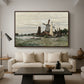 Windmill at Zaandam, 1871 by Claude Monet as a walnut floater framed canvas featuring a single windmill beside water with surrounding buildings and sky, displayed above a sofa in a modern living room.
