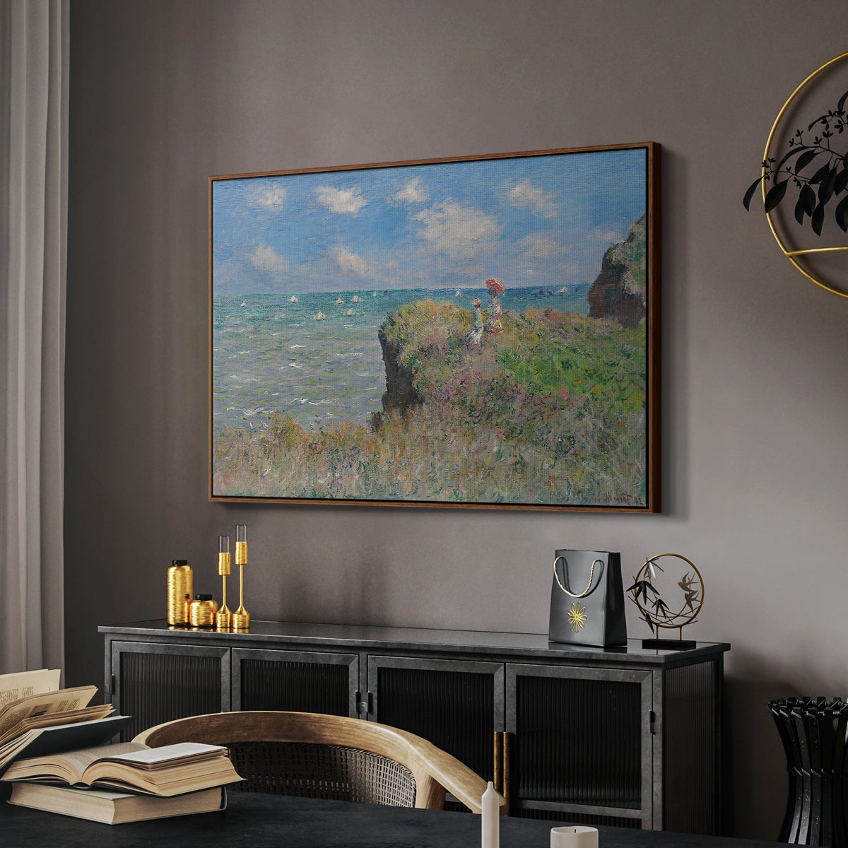 The Cliff Walk at Pourville, 1882 by Claude Monet in a walnut floater framed canvas featuring a coastal cliff scene with grass, wind, and expansive sea view, displayed above a desk in a dark home office interior.