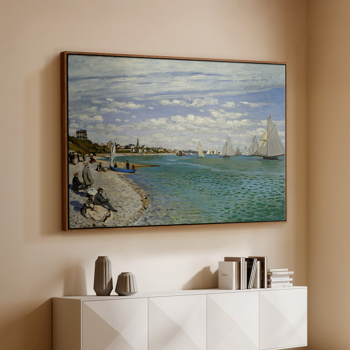 Walnut floater framed canvas of Regatta at Sainte-Adresse, 1867 by Claude Monet, featuring a lively regatta scene with boats and people on beach above a console cabinet in a minimalist entryway.