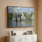 Walnut floater framed canvas of Houses on the Zaan River at Zaandam, 1871 by Claude Monet, featuring an impressionist riverside village with colorful buildings above a console cabinet in a minimalist entryway.