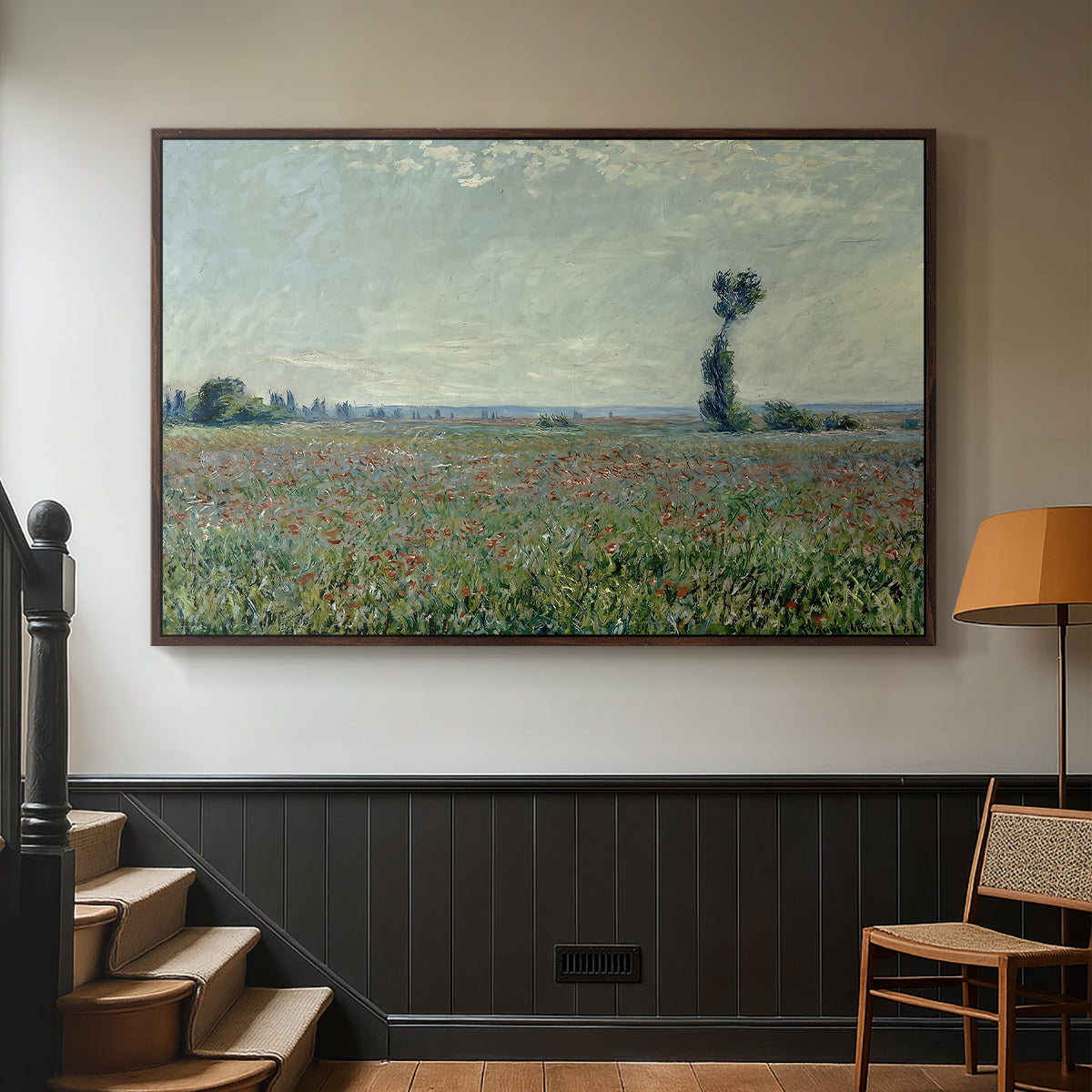 Walnut floater framed canvas featuring a natural field scene with vibrant red flowers, displayed in a hallway near a staircase.