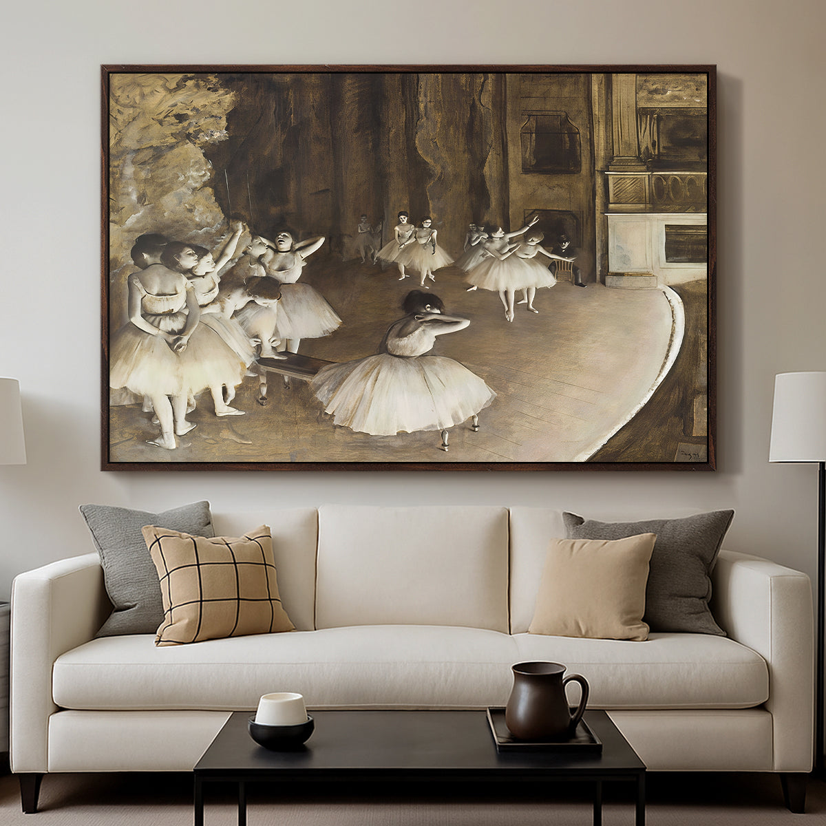 The Rehearsal of the Ballet Onstage, 1874 by Edgar Degas displayed in a walnut floater framed canvas above a sofa in a clean living room.