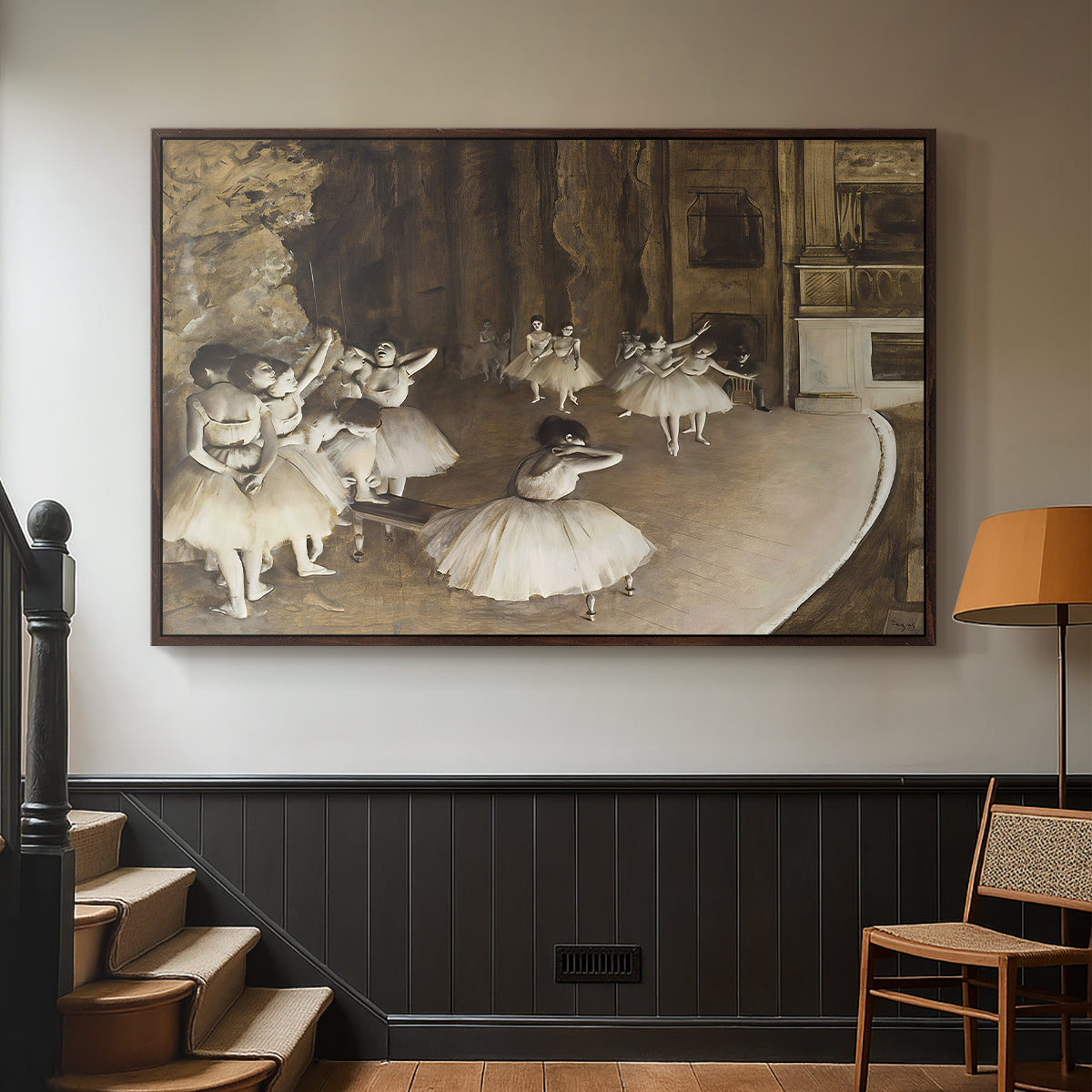 Walnut floater framed canvas featuring dancers arranged on stage with visible set and depth, displayed in a hallway near a staircase.