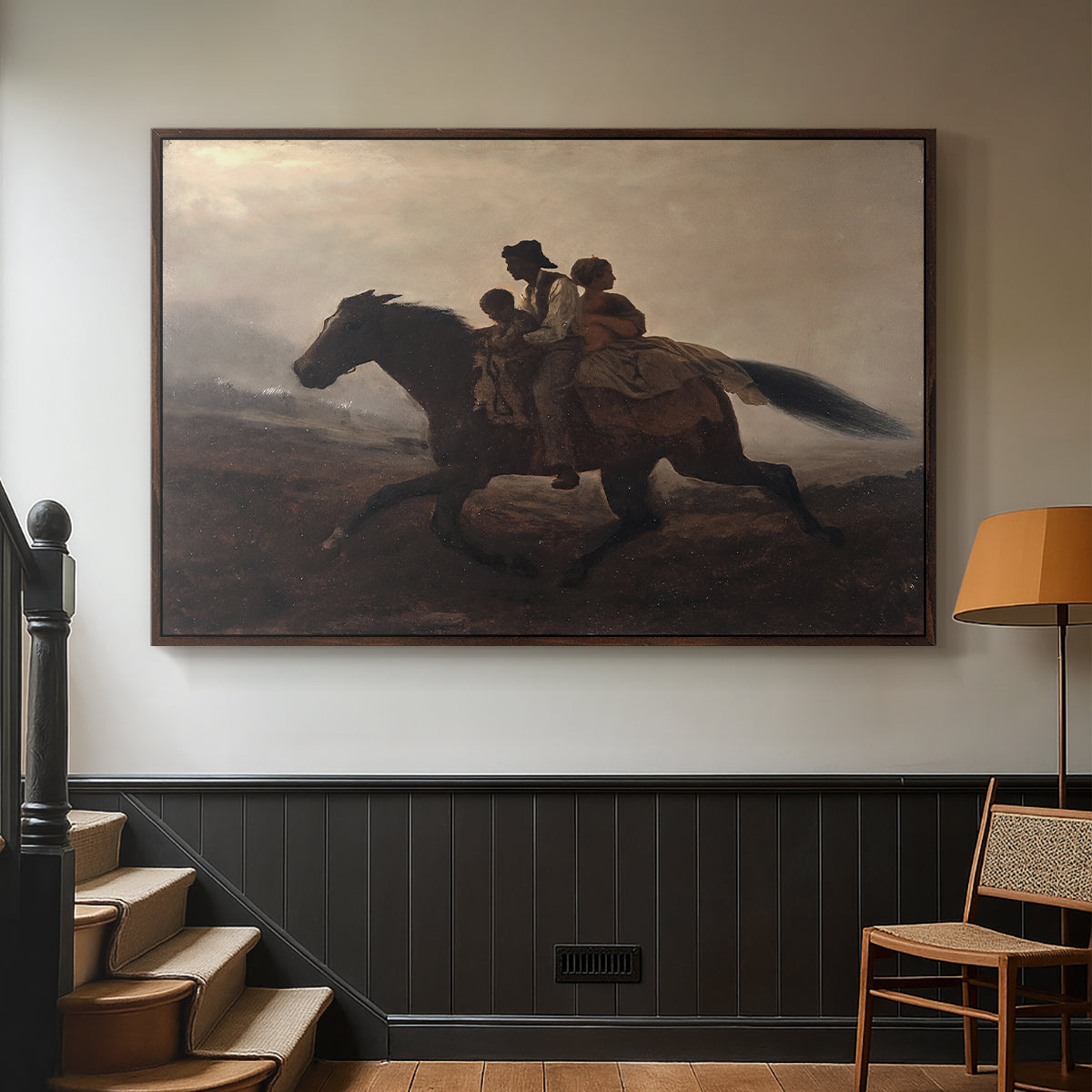 Walnut floater framed canvas featuring figures on horse moving swiftly through shadowy landscape, displayed in a hallway near a staircase.