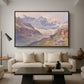 Odenwinklkees with the Johannisberg, 1902 by Edward Theodore Compton as a walnut floater framed canvas featuring an alpine glacier landscape with rugged peaks and snow-covered terrain, displayed above a sofa in a modern living room.